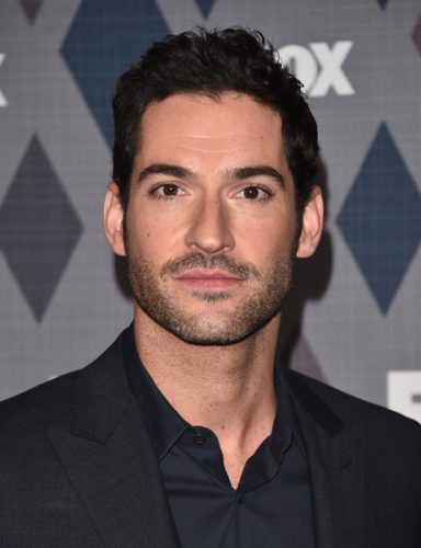 Lucifer Morningstar is very good looking in this portrait, wearing a black suit.